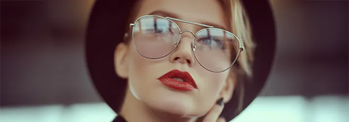 Eye Doctor Santa Ana CA Aesthetics A stylish young woman wearing reflective glasses posing for the camera.