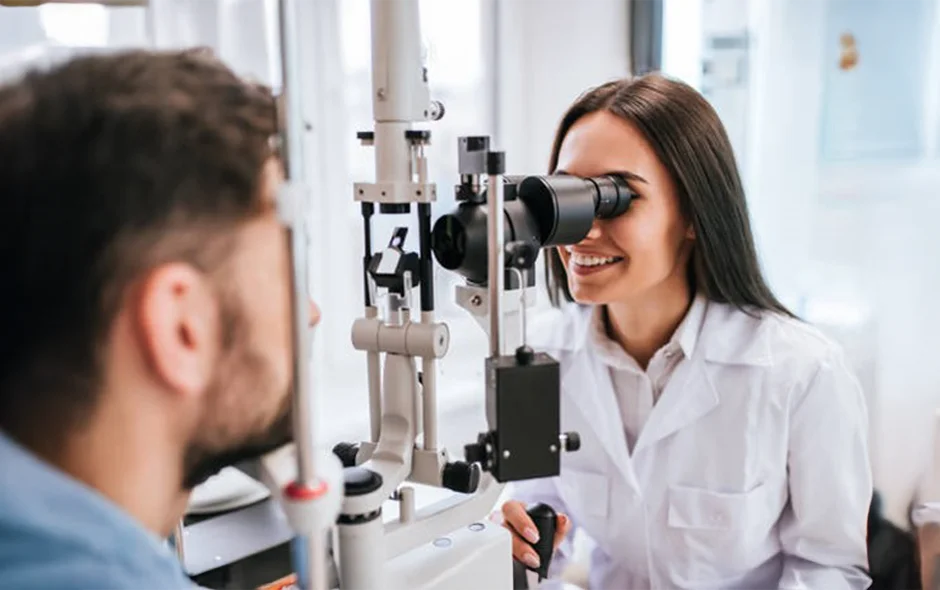A doctor using diagnostic tools to examine a male patient's eyes